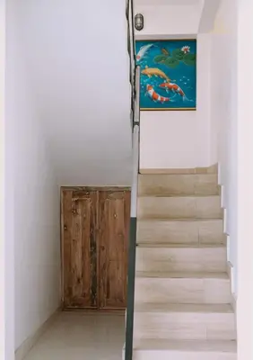 a staircase in a room with a painting on the wall at Mika Estate Property in Seminyak