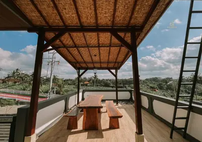 a balcony with benches and a roof with a view at Mika Estate Property in Seminyak