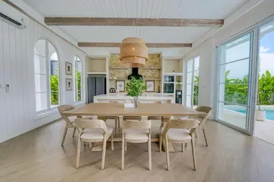 a dining room with a wooden table and chairs at Villa Aclasa Luxery 4BR Retreat in Berawa, Canggu in Canggu