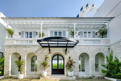 a white brick house with a black door at Villa Aclasa Luxery 4BR Retreat in Berawa, Canggu in Canggu