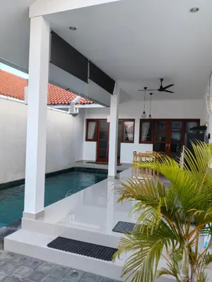 a swimming pool in a villa with a house at Villa Cassia Jimbaran in Jimbaran
