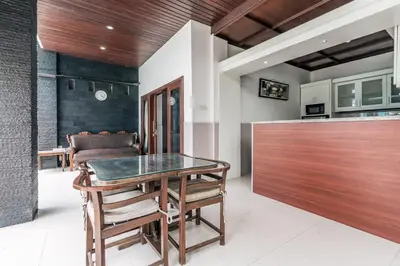 a dining room with a table and some chairs at Villa Nakula - Managed By Chayah Bali Villa Group in Seminyak