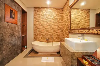 a bathroom with a sink and a bath tub at Maharaja Villas Seminyak by Humus Hospitality in Kerobokan