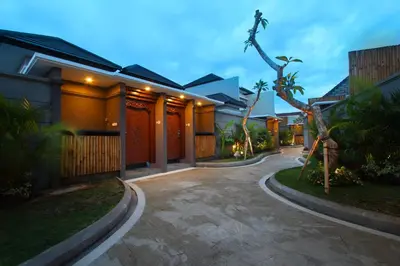 a driveway leading to a house at night at Maharaja Villas Seminyak by Humus Hospitality in Kerobokan