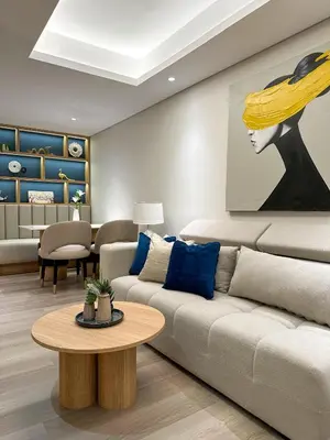 a living room with a couch and a table at MODERN 2 BEDROOM LAVAYA OAKWOOD APARTMENT, Nusa Dua in Nusa Dua