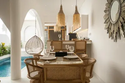 a dining room with a table and chairs and a pool at Brand New Villa 2BR with Private Pool near Seminyak by BaliSuperHost in Seminyak