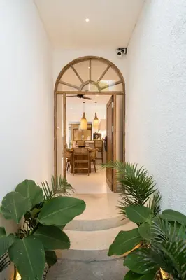 an archway leading into a dining room with plants at Brand New Villa 2BR with Private Pool near Seminyak by BaliSuperHost in Seminyak