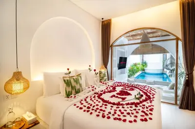 a bedroom with a bed with red roses on it at Brand New Villa 2BR with Private Pool near Seminyak by BaliSuperHost in Seminyak