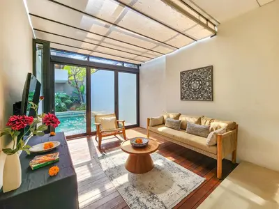 a living room with a couch and a table at Silk Umalas by Nagisa Bali in Kerobokan