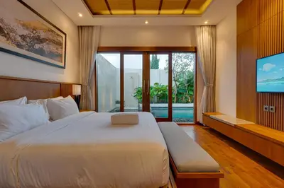 a bedroom with a large bed and a tv at New! Villa Taman Seminyak 01 near Double Six Beach in Seminyak