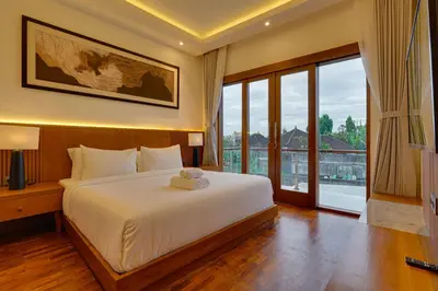 a bedroom with a large bed and a large window at New! Villa Taman Seminyak 01 near Double Six Beach in Seminyak