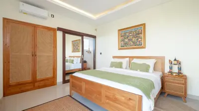 a bedroom with a large bed and a window at The Lange Estate in Seminyak