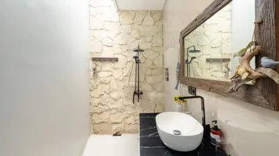a bathroom with a sink and a mirror at The Lange Estate in Seminyak