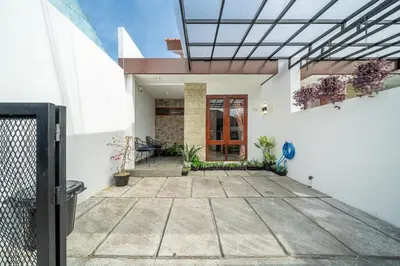 a house with a glass ceiling and a patio at Jimbaran Retreat in Jimbaran