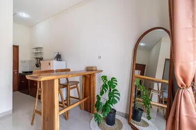 a room with a mirror and a table and a counter at Jimbaran Retreat in Jimbaran