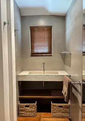 a bathroom with a large sink and two baskets at Tropical Townhouse 3 Bedrooms Seminyak in Seminyak