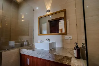 a bathroom with a sink and a mirror at Homely Bali at Seminyak in Kerobokan