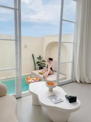 a woman sitting on a couch in a living room at Villa Azura in Perean
