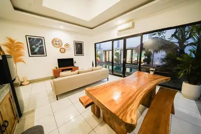 a living room with a table and a couch at Peaceful private 3BR pool villa in heart of Bali in Legian