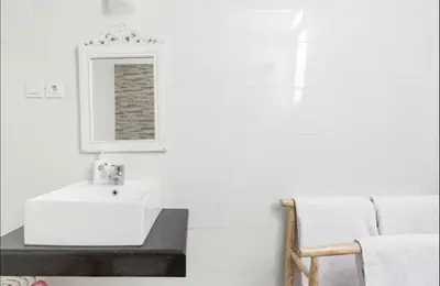 a bathroom with a white sink and a mirror at Walk to Beach - Private 3 Bedroom Villa Roshi Seminyak in Seminyak
