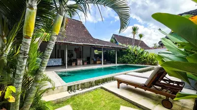 a swimming pool in front of a villa at Villa Louise in Badung