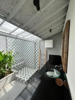 a bathroom with a sink in a room at Villa Louise in Badung
