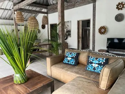 a living room with a couch and a table at Villa Louise in Badung