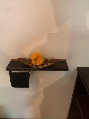 a orange flower sitting on a shelf on a wall at My secret home ( full villa) in Seminyak
