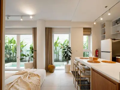 a kitchen with a white counter and a kitchen island at Berawa Luxury Retreat - The Cruise Canggu in Canggu