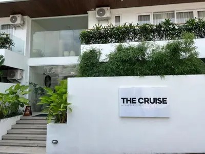 a white building with a sign that reads the cruise at Berawa Luxury Retreat - The Cruise Canggu in Canggu