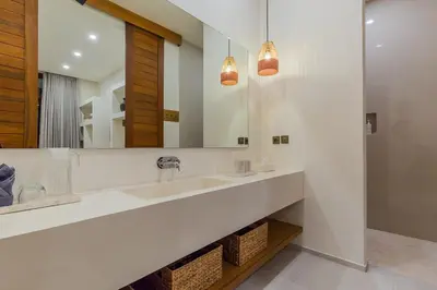 a bathroom with two sinks and a large mirror at Villa Trindade 5BR, 15m Pool in Seminyak