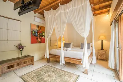 a bedroom with a bed with a canopy at Villa Umah Maya in Seminyak