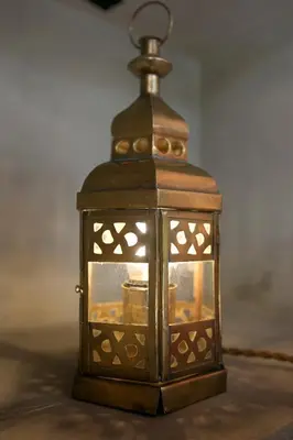 a lantern is sitting on top of a table at Villa Inde Noi - Beautiful stylish bohemian 2bdrs villa - Kerobokan in Kerobokan
