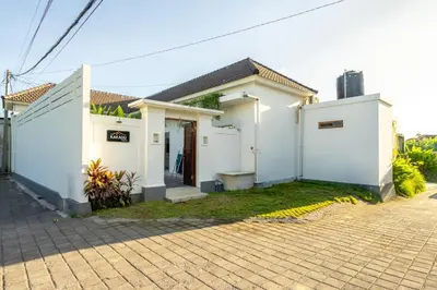 a white house with a brick driveway at The Kakadu - A new modern 2BR Villa with private pool in Seminyak in Seminyak