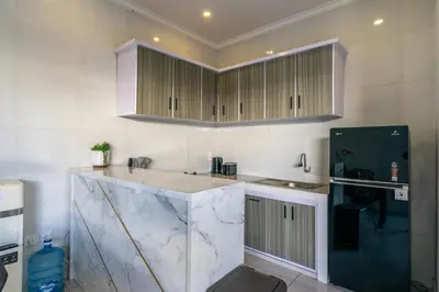 a kitchen with marble counter tops and cabinets at The Kakadu - A new modern 2BR Villa with private pool in Seminyak in Seminyak