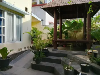a garden outside a house with potted plants at Terace Campus A4 in Jimbaran