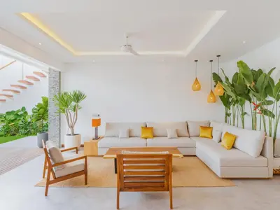 a living room with a couch and a table at Lux 500sqm 5BR Villa, 400m to FINNS & Canggu Beach in Canggu