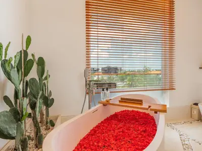 a bathtub filled with red carpet next to a window at Lux 500sqm 5BR Villa, 400m to FINNS & Canggu Beach in Canggu