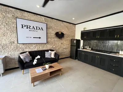 a living room with a couch and a kitchen at Villa Mawar Seminyak in Seminyak