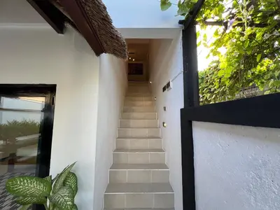 a stairway leading up to a house with a stair case at Villa Mawar Seminyak in Seminyak