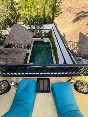 an overhead view of a swimming pool with blue pillows at Villa Mawar Seminyak in Seminyak