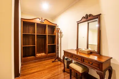 a dressing room with a desk and a mirror at Putri Bali Seminyak Villa in Seminyak