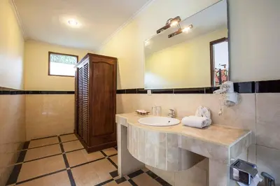 a bathroom with a sink and a mirror at Putri Bali Seminyak Villa in Seminyak
