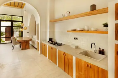 a large kitchen with a sink and a table at Balidroomvilla Sanur Mangrove - Full Serviced - Beachside in Sanur