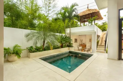a swimming pool in a backyard with a house at Balidroomvilla Sanur Mangrove - Full Serviced - Beachside in Sanur