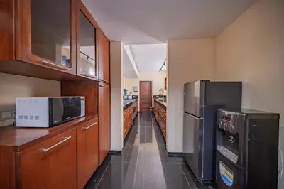 a kitchen with two refrigerators and a microwave at Villa Wibisana Beachside Luxury in Seminyak in Seminyak