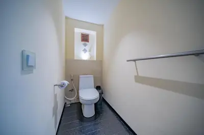 a bathroom with a white toilet in a room at Villa Wibisana Beachside Luxury in Seminyak in Seminyak