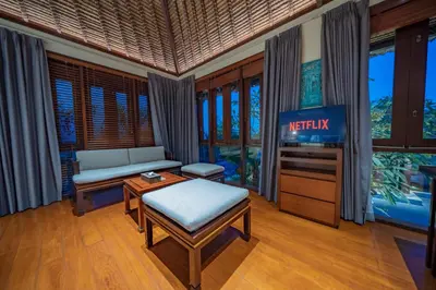 a living room with a tv and a couch at Villa Wibisana Beachside Luxury in Seminyak in Seminyak