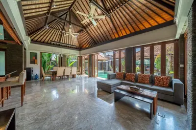 a living room with a couch and a table at Beachside Villa Di Bucu in Canggu
