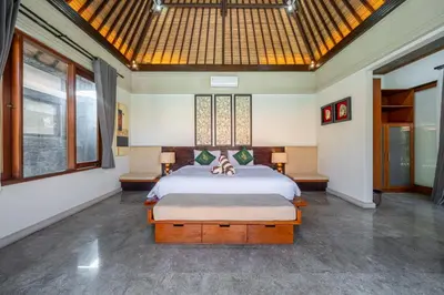 a bedroom with a large bed in a room at Beachside Villa Di Bucu in Canggu